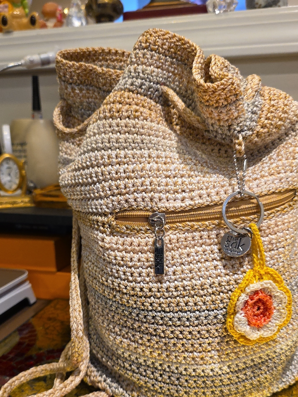The Sak Crochet Drawstring Backpack in Beige and Yellow Accent